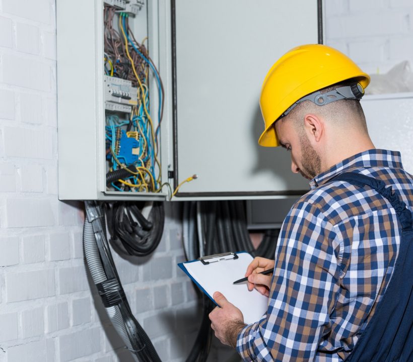 professional-electrician-inspecting-wires-in-electrical-box.jpg